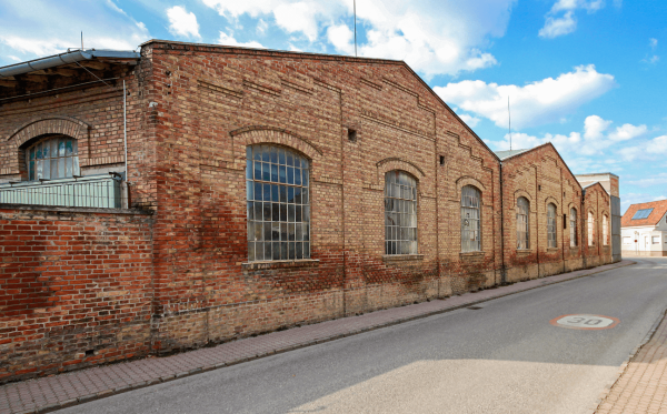 Outside view of the building with large factory windows.