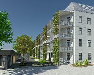 The image shows a modern building with green balconies and solar panels on the roof. In the foreground, there is a tree, bike racks, and a paved walkway.