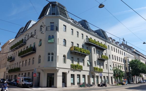 Mehrstöckiges Gebäude mit begrünten Balkonen